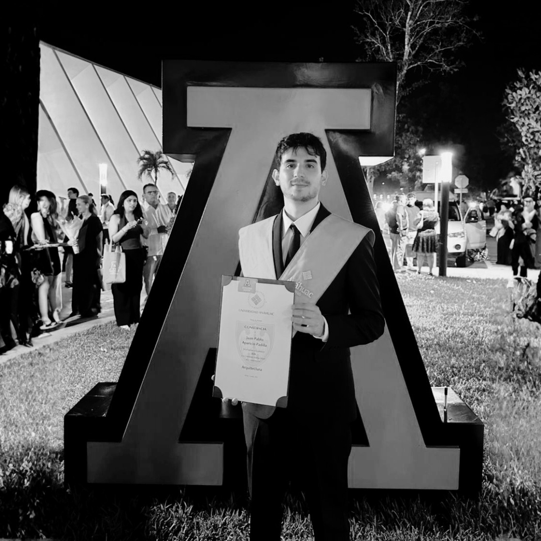Juan on his architecture graduation day, holding his degree